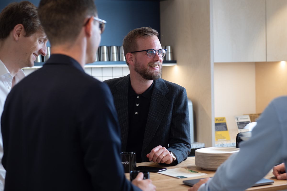 Sales professionals meeting with a client, representing consultants and practitioners collaboration